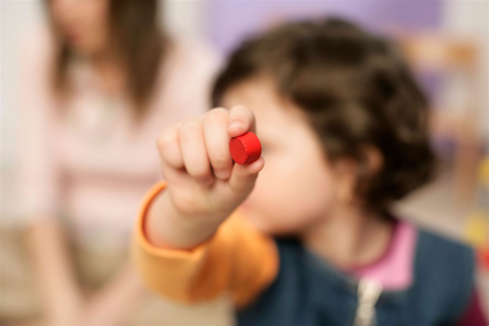 Kindergarten-age child concentrating on an activity